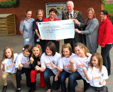 The cheque is handed over to Chesterfield Royal for the Cold Cot after money was raised byt eh girls walking for the SANDS charity.