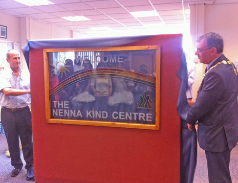 The Mayor of Chesterfield, Cllr Donal Parsons, unveils the stained glass window at the Nenna Kind Centre's official opening with window designer Christopher Turner