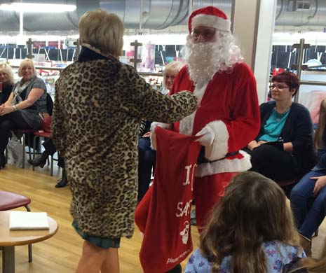 Santa was also there to strut his stuff and give out gifts to customers!