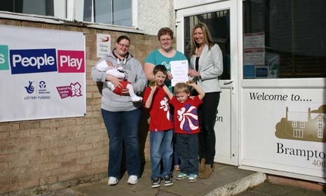 Winner Terri (with Baby Evie), Rachael and sons Lewis and Joshua receive their prize from Brampton Manor's Isobel Gibbions