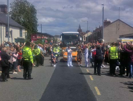 Molly Mee takes over as the Torch Relay heads along Chatsworth Road as it leaves Chesterfield town centre