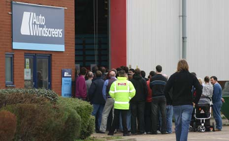 Auto Windscreens employees crowd the fitting centre doors to hear the fate of the company