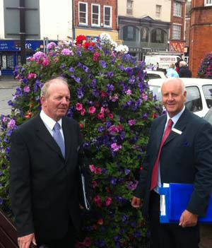 Judges Peter Benham and Ken Richardson inspect the floral assets in the town