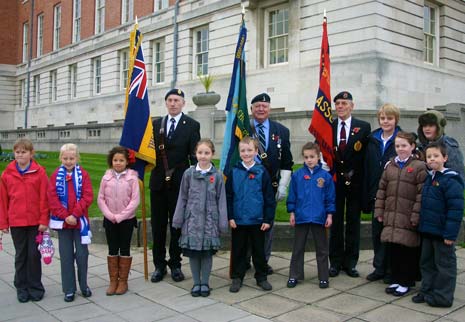 Standard Bearers (l to r) Bill Miller - Royal British Legion, George May - Royal Signals Association and John Collins - Royal Engineers Association with the children from New Whittington Primary School