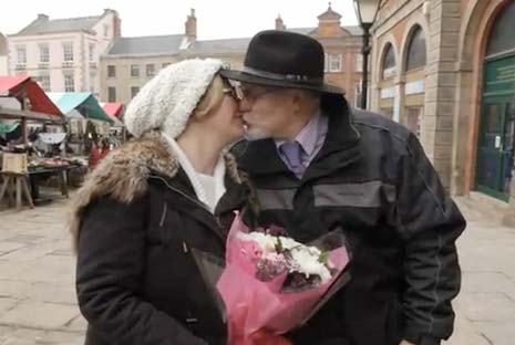 Ruth thanks Husband Tom with a kiss after being surprised by the Clinton's Choir