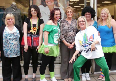 (l-r) Julie Glossop, Karima Deneche, Sarah Bartram, Competition winner Eileen Cann, Jackie Harrison, Jackie Feather and front, Caroline Smith, Store Manager with their 80's gear on celebrating Bon Marche's 30th birthday