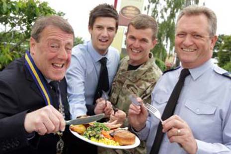 Adam Simpson (second from left) from Crown Carveries presents a carvery to (l-r) Veteran Andy Greg, WO2 Ian Collins (Army) and W01 Dennis Hawkins (RAF)