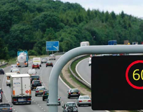 Smart motorways add extra capacity by converting the hard shoulder into a permanent running lane which is supported and controlled by variable mandatory speed limits to manage traffic and reduce congestion.