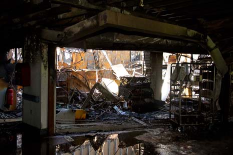 Images of the hospital's main entrance and shop area after the fire