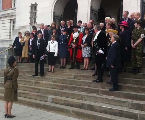 The salute is taken on the Town Hall steps.