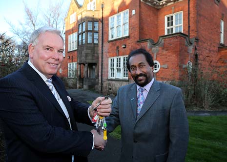 Cllr Brian Ridgway, left, hands over the keys to St Helena Centre to Hari Punchihewa, from the University of Derby