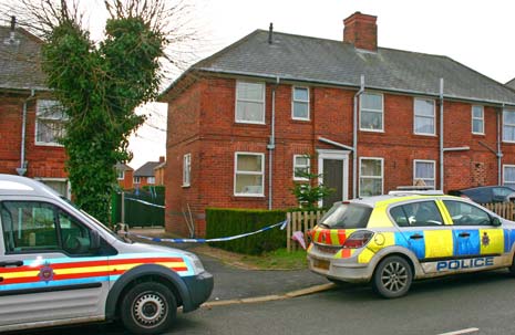 Police vehicles remain outside the house on Tapton View Road where Sharon Knapper's assault took place