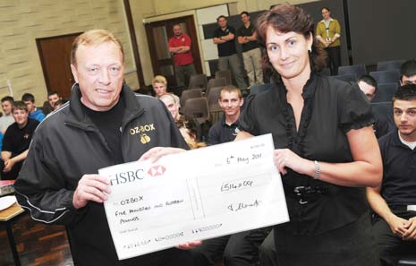 Ozbox Founder, Steve Osbaldeston receives the funds raised by College students from Public Services Lecturer, Tracy Clements.