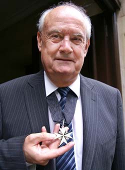 Ken Cook receives his award from the Queen in London