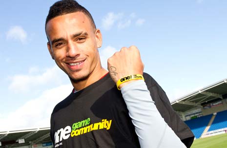 Dean Morgan wears the 'Kick It Out' wristband