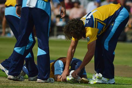 Wes Durston lies hurt while Vikings' Ryan Sidebottom helps him until the Physio arrived