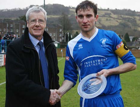 Captain fantastic' James Lukic receives a momento to mark his record 600th appearance from Matlock legend Mick Fenoughty who's still top with 672!