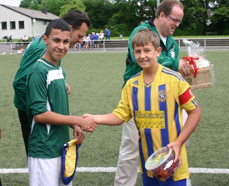 The team captains exhange gifts before kick off.