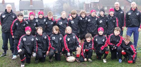 Pictured are the squad in their new tops with coaches Mike Curley, Andrew Hawkins and Chris Brailsford.