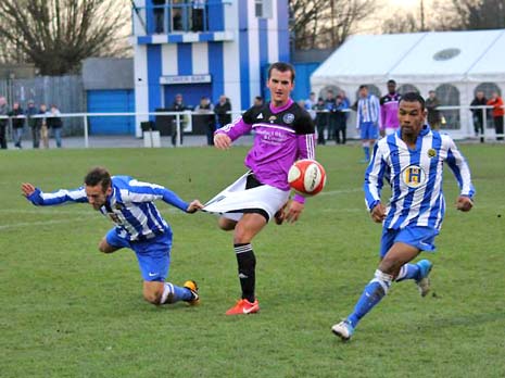 Jamie Smith (left) tries to help Reece Littlejohn by distracting the Garforth player by any means necessary!